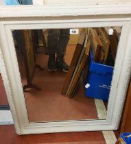 A white painted framed oblong wall mirror - sold with a stained wood framed fire screen with