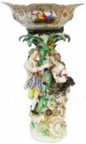 An antique Meissen porcelain figural centrepiece with Rococo scroll and leaf flower encrusted column