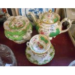 A mid 19th Century bone china teapot with hand painted floral sprays within a green panel ground and