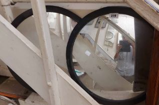 A pair of 45cm diameter ebonised framed convex mirror panels