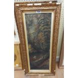 A pair of old gilt framed oils on board in narrow portrait format, one depicting a woodland river,