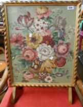 A reproduction giltwood framed fire screen with printed floral spray on textile under glass, set