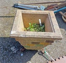 A concrete planter of tapered square form, set on wrought iron scroll feet - sold with a