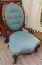 A Victorian mahogany show frame nursing chair with oval button back and upholstered seat, flanking