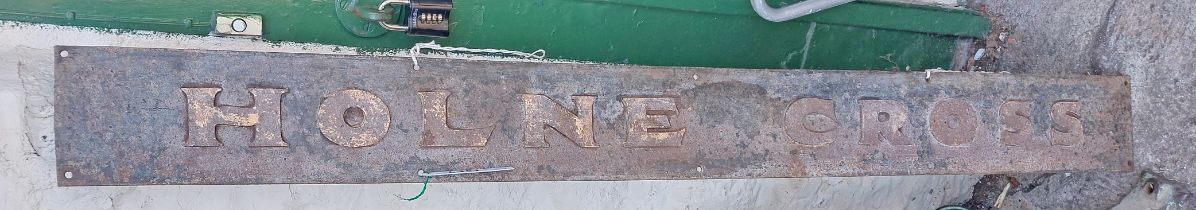 An old cast-iron sign for Holne Cross, with remains of painted finish