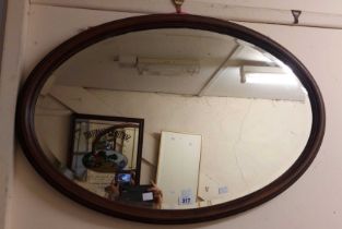 An early 20th Century mahogany and strung framed bevelled oval wall mirror