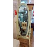 A modern painted wood framed cheval mirror with oval plate, set on turned pillars and splayed legs