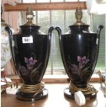 A pair of black glazed pottery table lamps with transfer-printed floral decoration - a/f