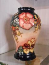 A Moorcroft vase of baluster form with tube-lined floral decoration - impressed marks and painted WM