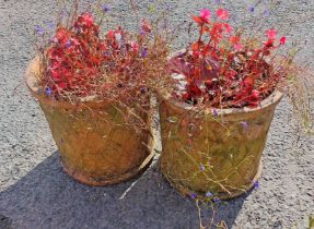 A pair of old terracotta garden pots with moulded trellis decoration - planted with flowers