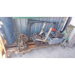 A large old lathe with cast-iron legs, frame and carriages, cutting and turning fittings, motor,