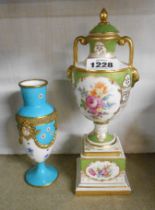 A German porcelain lidded urn on stand with hand painted floral decoration on an apple green and