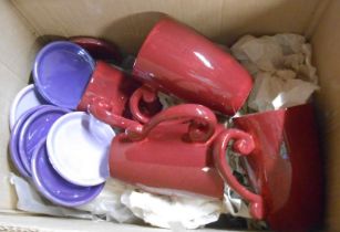 A box containing a quantity of ceramic mugs and coaster