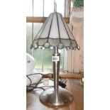 A modern metal table lamp, with Tiffany style glass shade