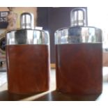 A leather case containing a pair of silver plate mounted glass flasks