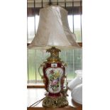 A 20th Century porcelain table lamp of waisted form, with Rococo scroll handles and decorative