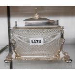 A cut glass oblong box with silver plated hinged lid, set on a plated stand with swing handle