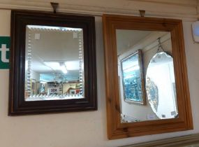 A small stained wood framed bevelled oblong wall mirror with knurled cut decoration - sold with a