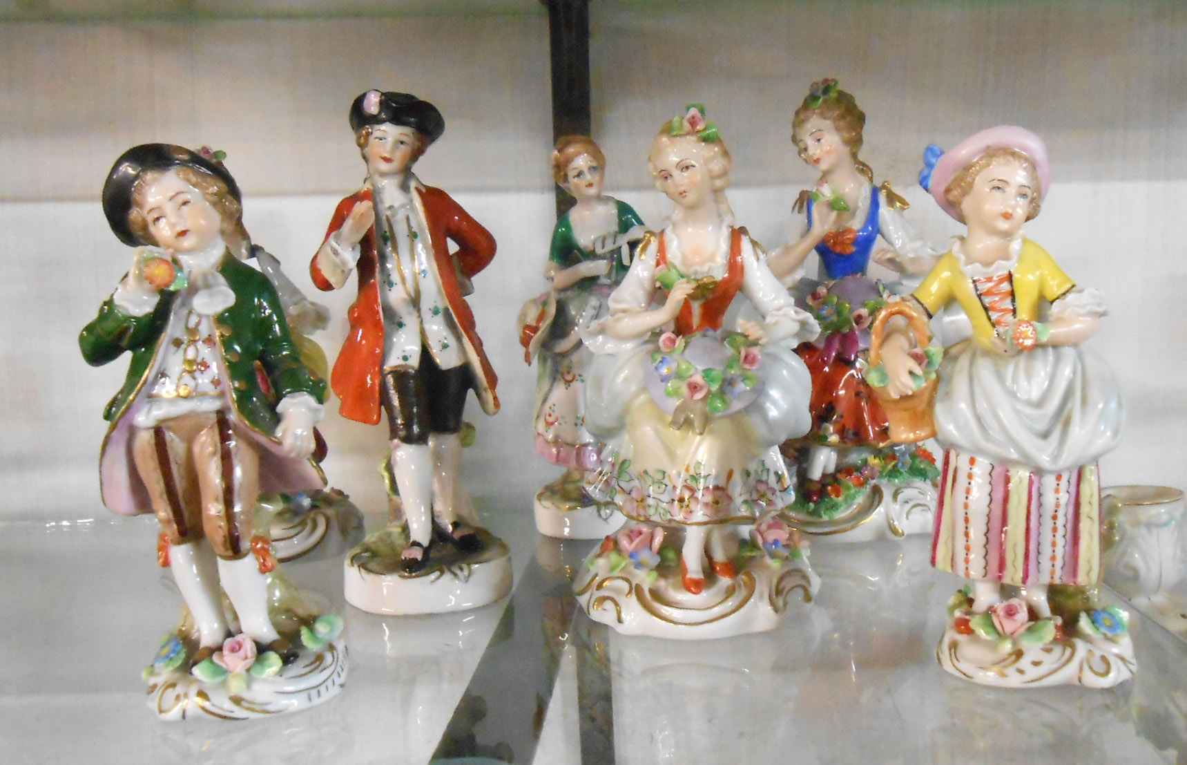 Seven German porcelain figurines of typical Rococo style, depicting characters in period dress