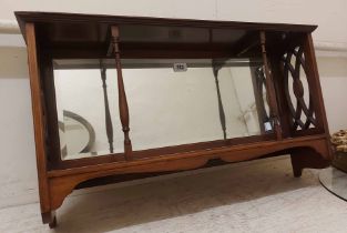 A 72cm early 20th Century mahogany and strung wall shelf with bevelled oblong mirror panel to
