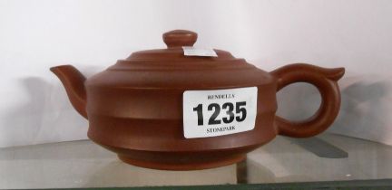 A Chinese Yixing Zisha clay teapot of turned form with impressed circular seal mark to base
