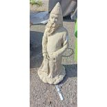 A concrete garden statue depicting the wizard Merlin