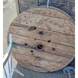 A pair of large wooden cider press wheels