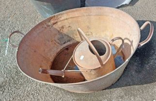 An old galvanised tin bath - sold with a similar watering can