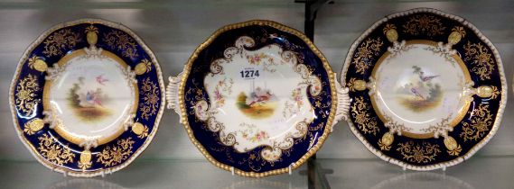 A pair of Coalport bone china cabinet plates decorated with central hand painted panels of exotic