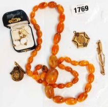 A yellow metal mounted small scent bottle - sold with a reconstituted amber graduated bead necklace,