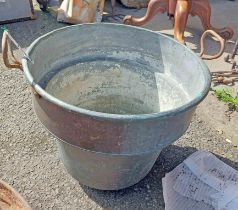 A large old two handled copper boiler