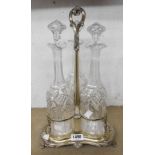 A silver plated decanter stand containing three tall cut glass Sherry decanters with stoppers