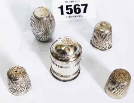 An antique white metal nutmeg grater and barrel pattern shaker - sold with two silver thimbles and a