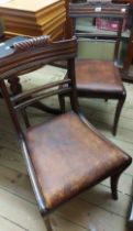 A set of four antique mahogany framed standard chairs with scroll backs and leather upholstered