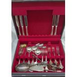 A stained wood canteen containing a quantity of assorted silver plated cutlery and a silver napkin