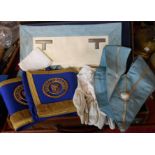 A suitcase containing a quantity of Masonic memorabilia including aprons, cuffs, sashes, etc. - From