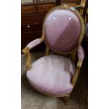 An old carved gilt wood chair with later valour upholstery