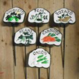 A set of six modern painted cast iron vegetable labels