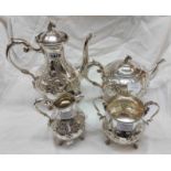 A late Victorian silver plated four piece tea set, with ornate embossed decoration and cast horse