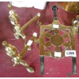 A 19th Century brass extending trivet with turned ebony handle - sold with a pair of cast brass fire