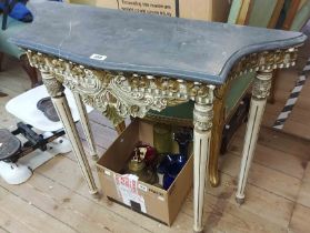 A 93cm Portuguese painted and parcel gilt hall table with shaped slate top, set on turned and fluted