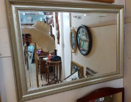 A modern gilt framed bevelled oblong wall mirror