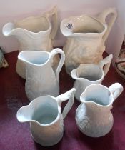 Six Portmeirion relief moulded Parian jugs of various size and form