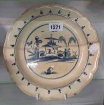 An 18th Century pearlware plate with hand painted decoration in blue, depicting a Pagoda in a
