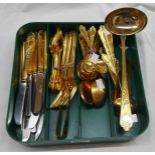 An SBS (German) twelve place setting of cutlery with ornate gold plated handles, including ladle