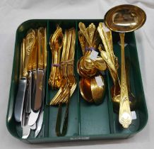 An SBS (German) twelve place setting of cutlery with ornate gold plated handles, including ladle