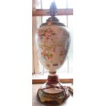 An early 20th Century porcelain table lamp with floral decoration and brass fittings