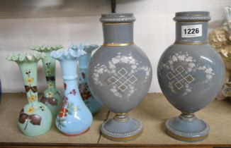 A pair of 19th Century grey opaque glass vases with white enamel and gilt decoration - sold with