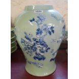 A large Chinese porcelain vase with molded decoration, depicting a flower vase and scholarly objects