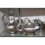 A 19th Century silver plated three piece tea set with porcelain insulators to teapot handle, cast